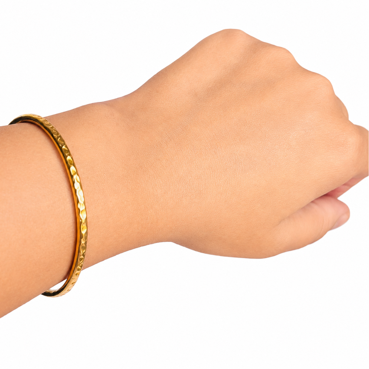 Gold bracelet on a wrist against a white background