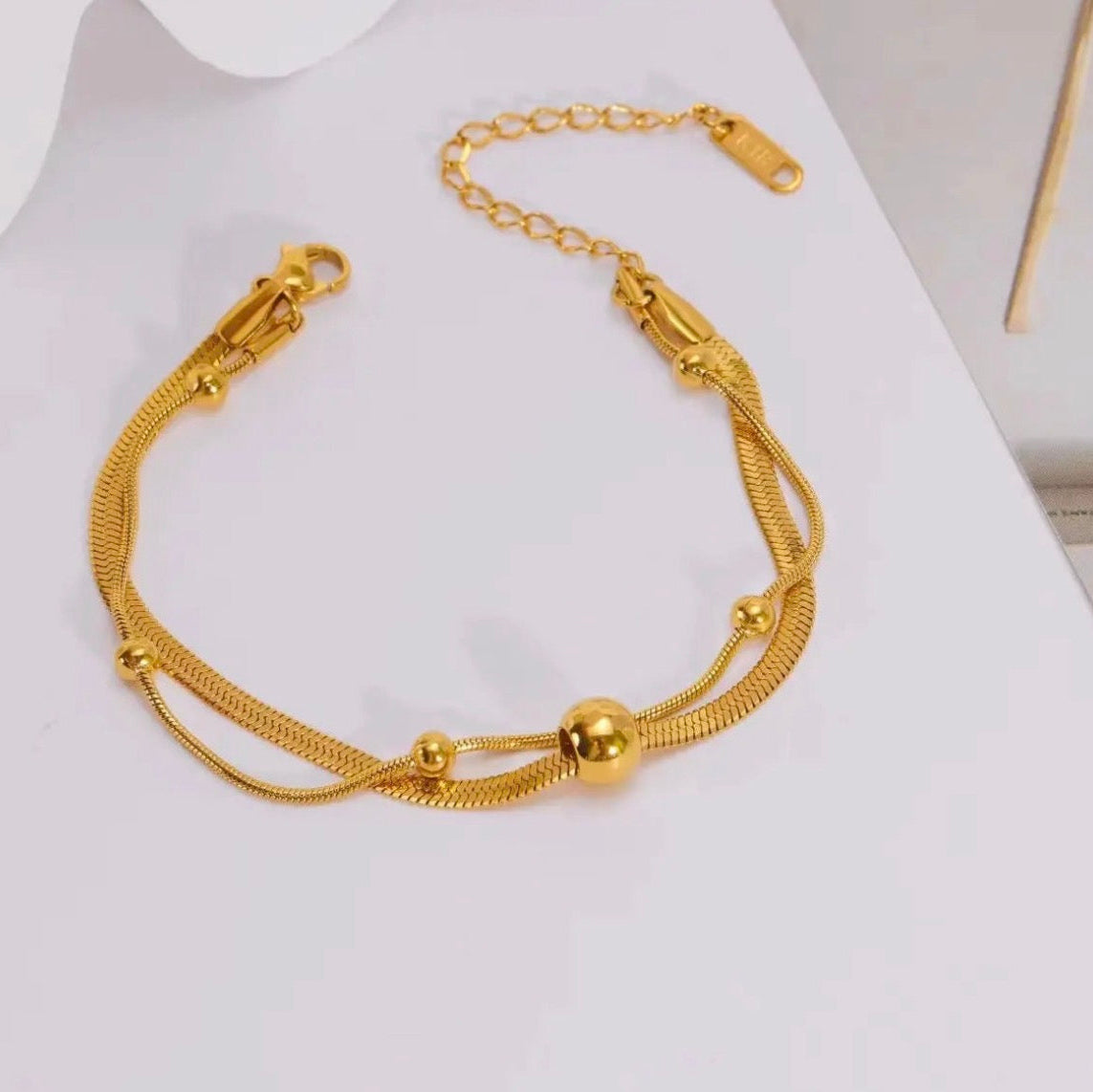 Gold bracelet on a white background