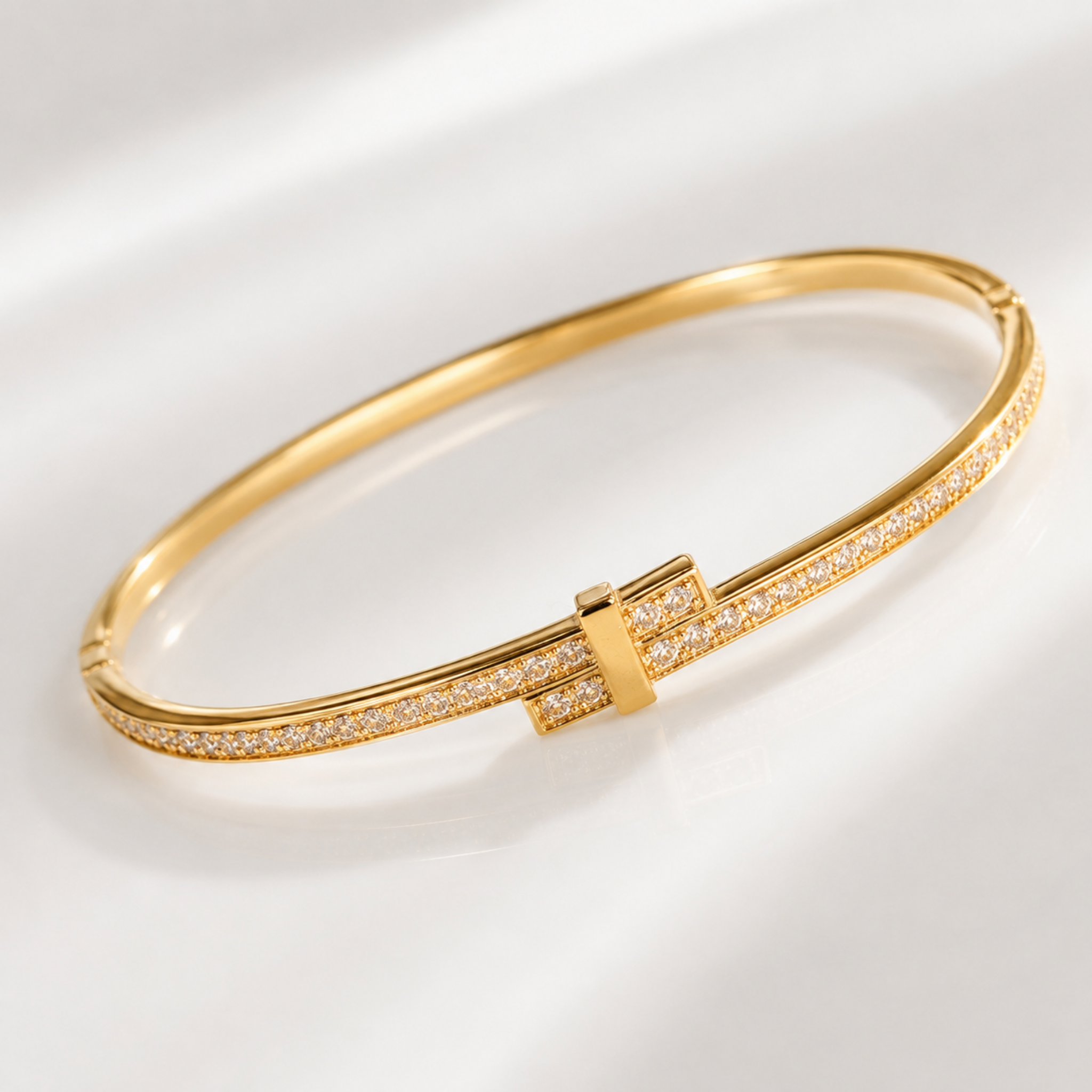 Gold bracelet with diamond accents on a light background